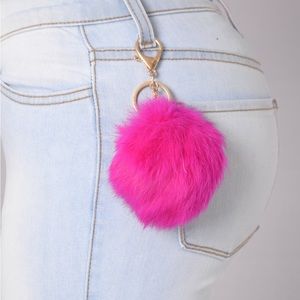 pink pom pom keychain with gold clasp from fashion nova